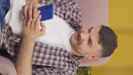 Vertical-video-of-Happy-and-happy-texting-man.